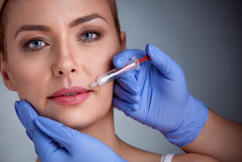 Woman having injection of  botox in lips,  beauty treatment